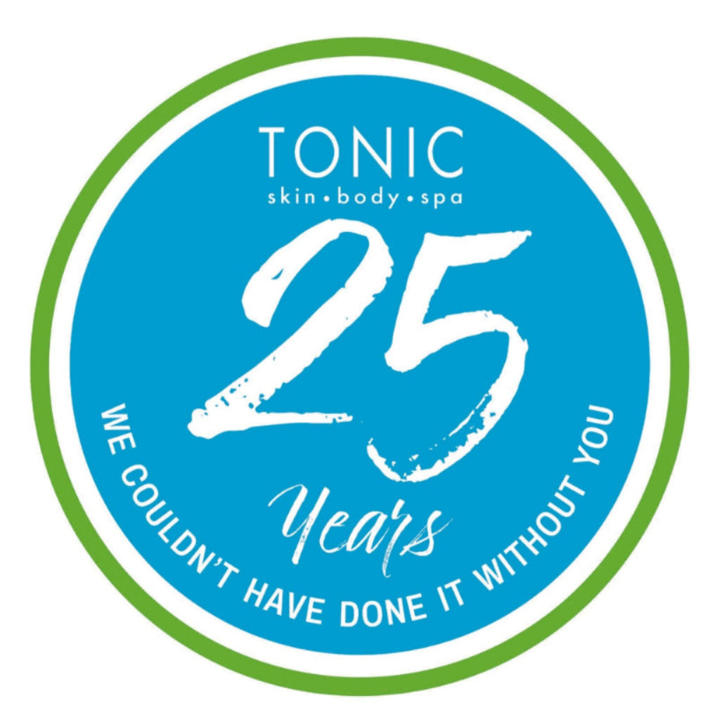 Circular logo for Tonic skin body spa celebrating 25 years with a blue center and green border.